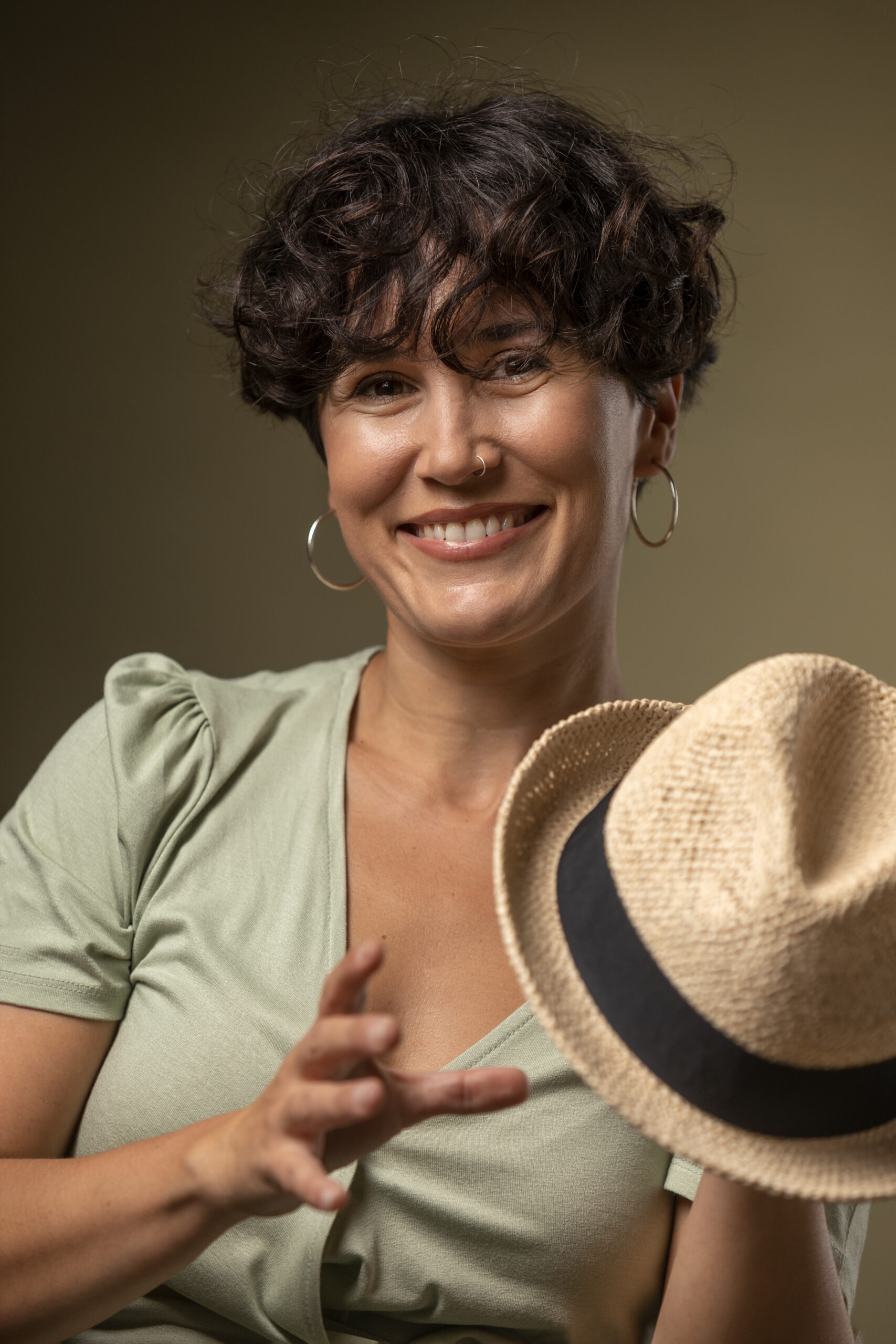 smiley woman holding hat medium shot