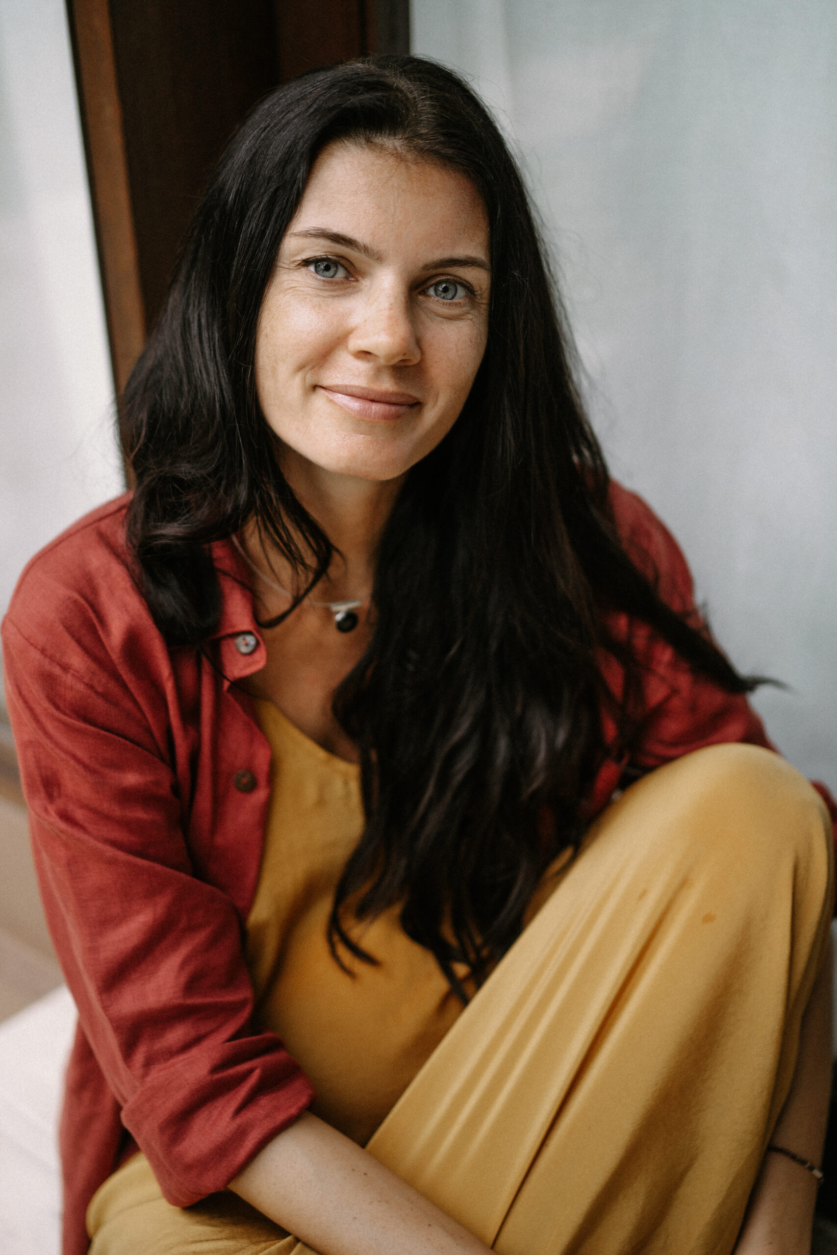 young pregnant woman with long dark hair tropical location